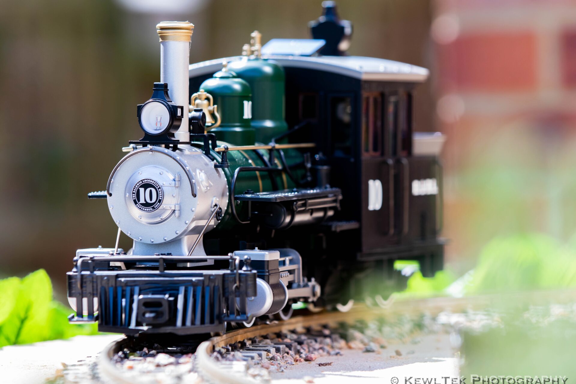 Image of a model train with lots of foreground and background blur.