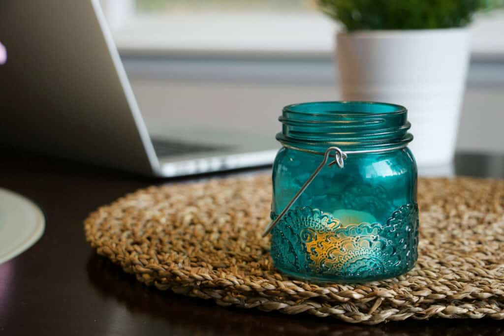 Photo of a blue glass jar taken with a Canon 80D and an 18–135mm kit lens at 50mm, showing less background blur due to a narrower aperture.