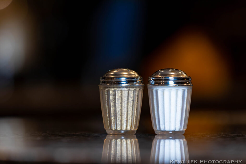 Image of salt and pepper shakers with surreal background blur bokeh.