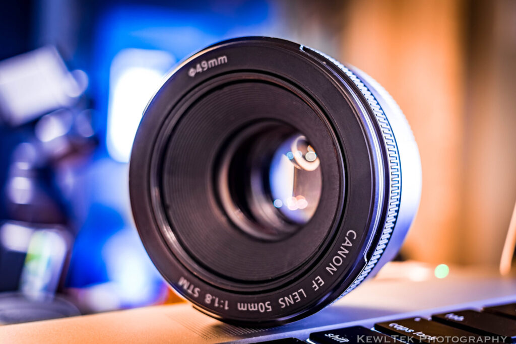 Close up image of a Canon 50mm f/1.8 lens with lots of background blur.