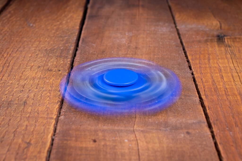 Slow camera shutter speed used to photograph a spinning toy results in motion blur.