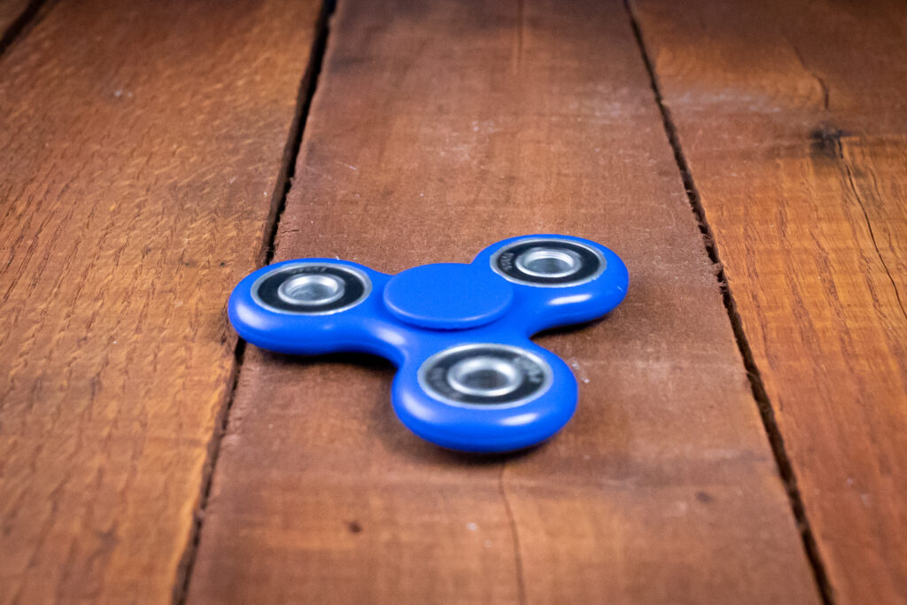 Fast camera shutter speed used to photograph a spinning toy results in freezing the object.