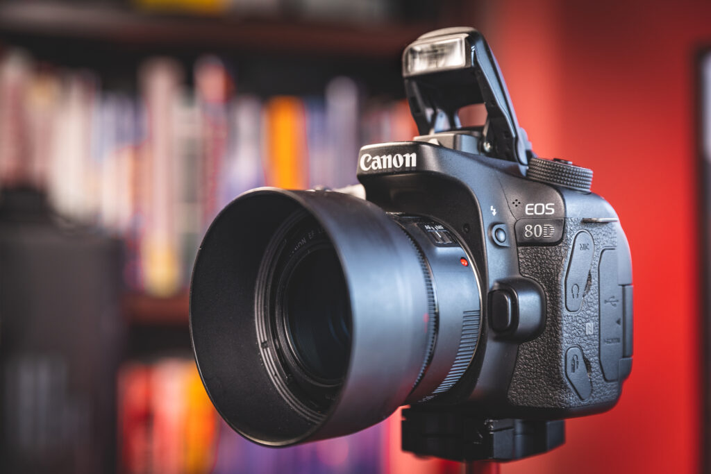 Image of a Canon 80D camera with pop-up flash enabled.