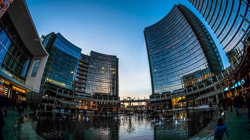 Image of skyscrapers in a city shot with a fisheye lens, causing the world to look warped.