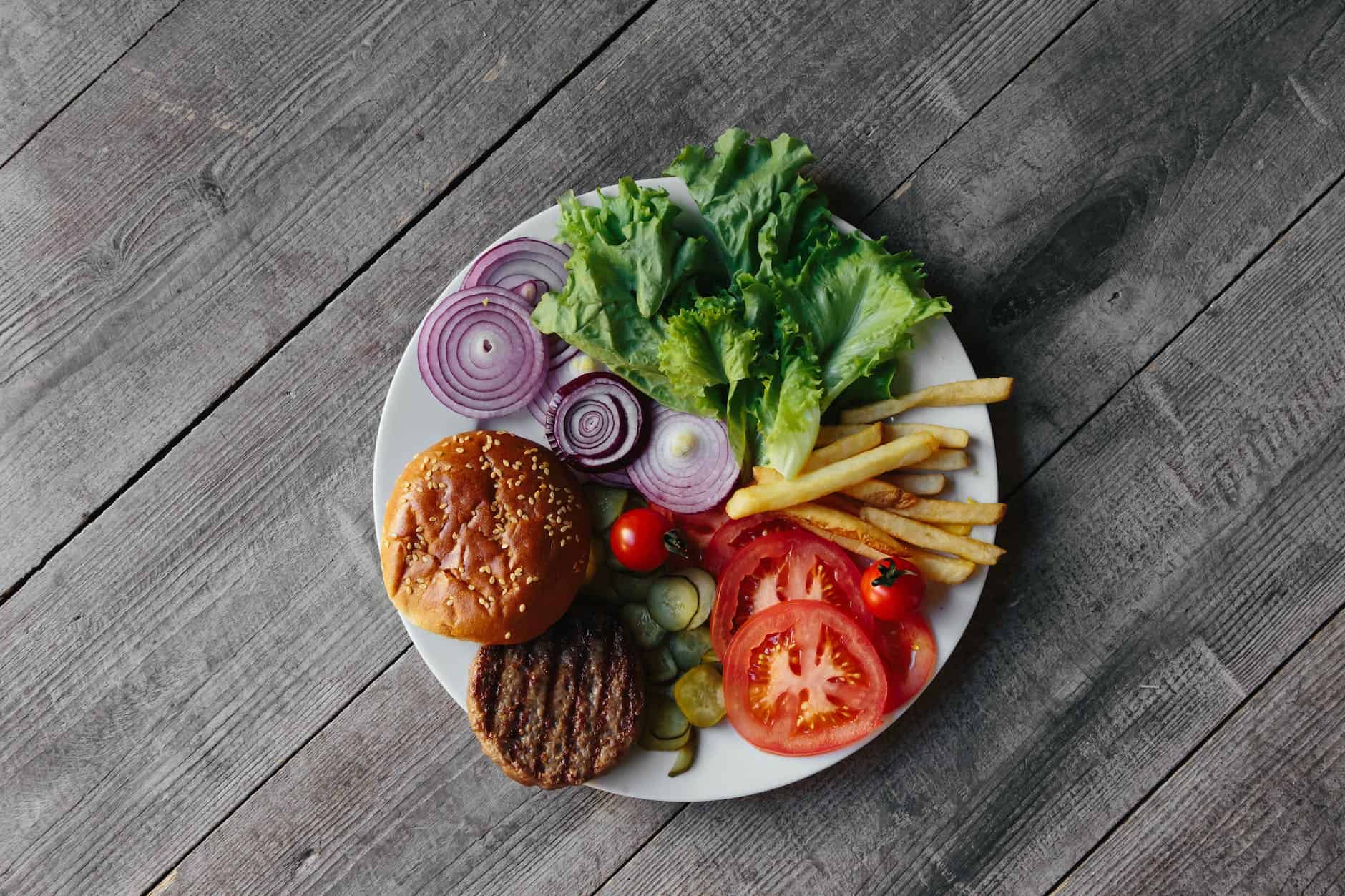 burger and fries with toppings on a plate
