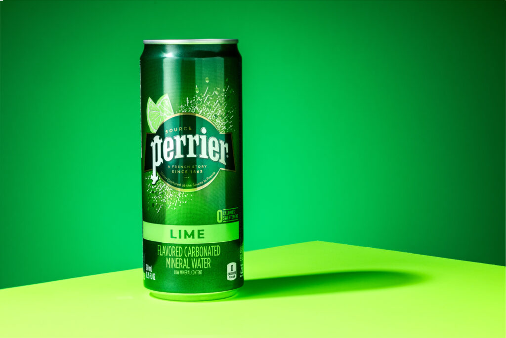 Perrier drink can on green background