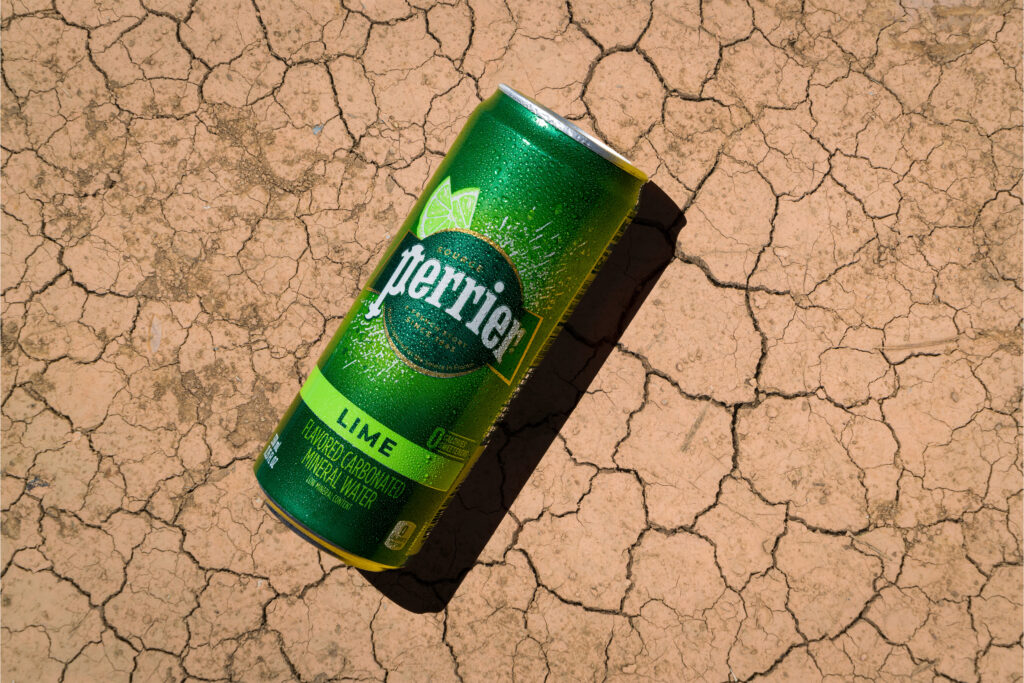 Perrier drink can on cracked parched desert surface