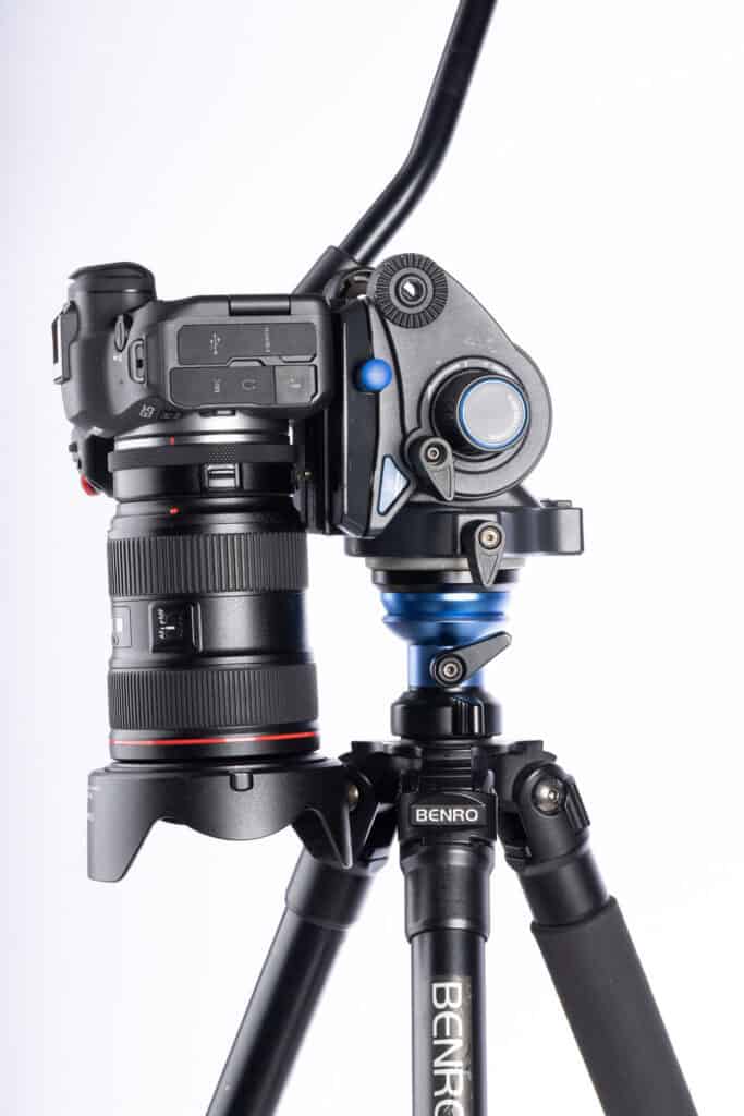 Full view of the Benro A2573FS6 tripod supporting a mirrorless camera and zoom lens mounted on the S6 PRO fluid video head.