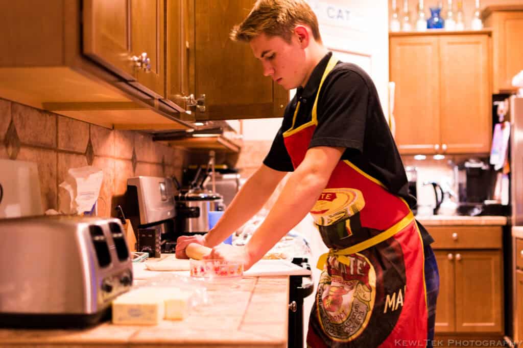 Indoor portrait under warm kitchen lighting showing orange color cast from incorrect white balance
